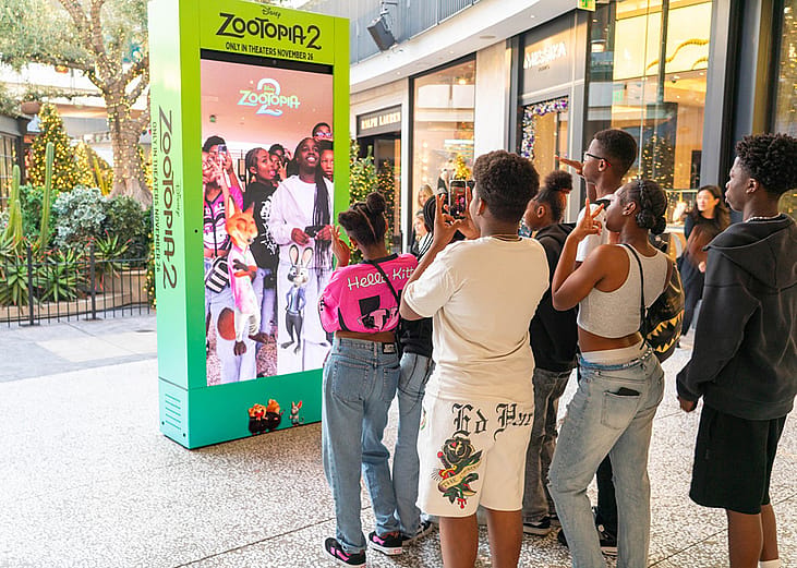 Young people in front of an interactive Zootopia 2 promotional activation kiosk at Westfield Century City.