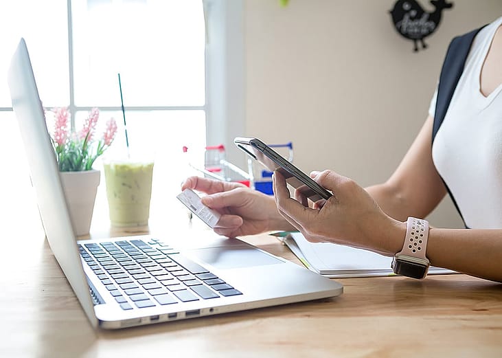 A person checking her credit card's details for a digital transaction from online shopping.