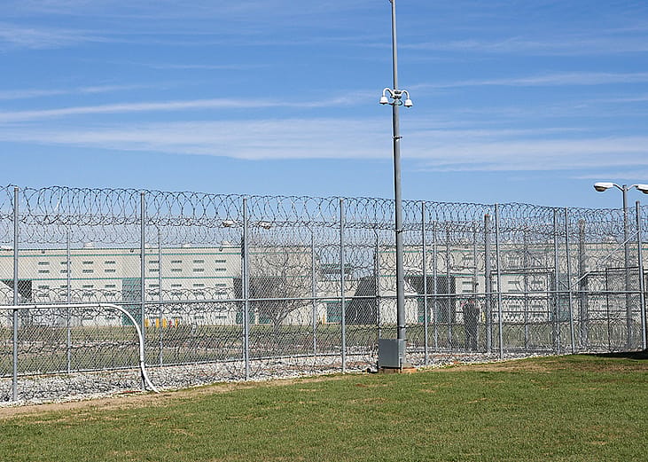 A fence, barbed wire and a guard are visible at the Allan B. Polunsky Unit, the prison that houses the 169 men on Texas' death row in Livingston, Texas.