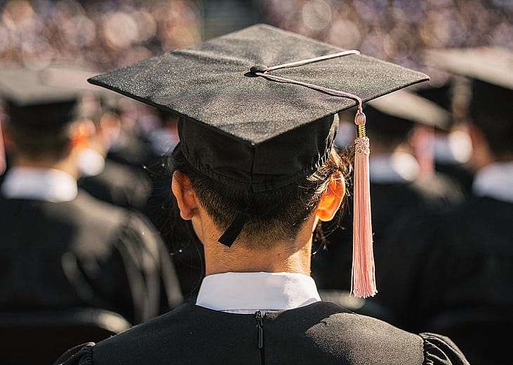 A back view of a university graduate during their ceremony.