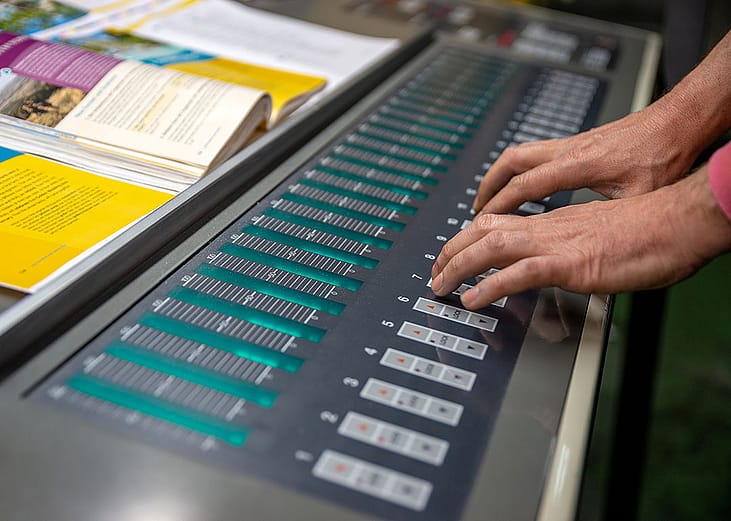 An operator working on an off-set printing machine.