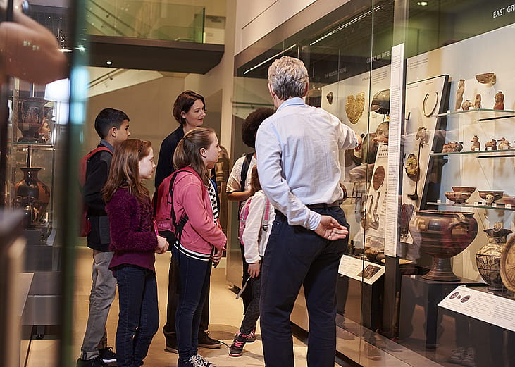 Students looking through artifacts during a museum visit. 