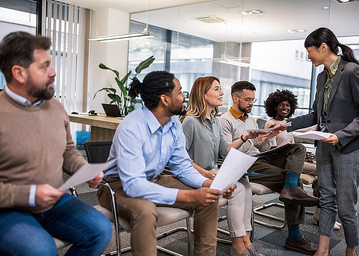 Corporate applicants waiting for a job interview in an office's lobby.