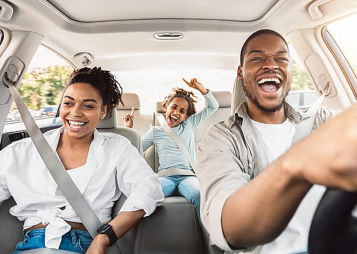 A happy family enjoying a summer road trip.
