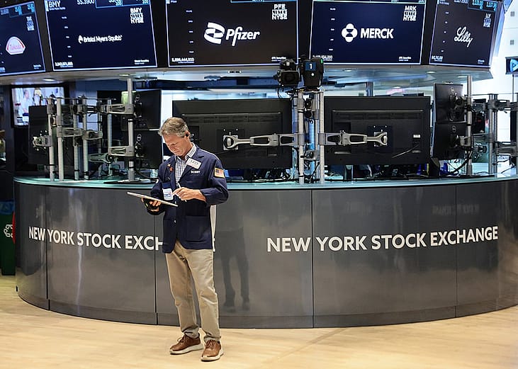 Traders work on the floor of the New York Stock Exchange during morning trading on June 26, 2026 in New York City. 