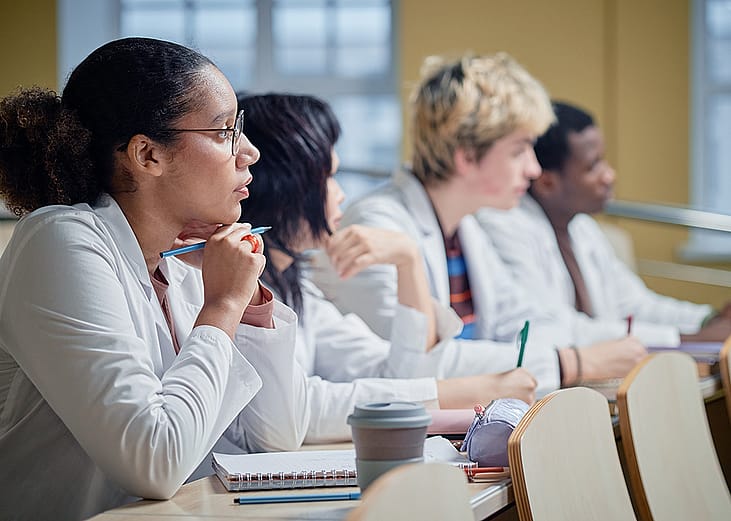 A class of medical students attentively listening to a lecture.