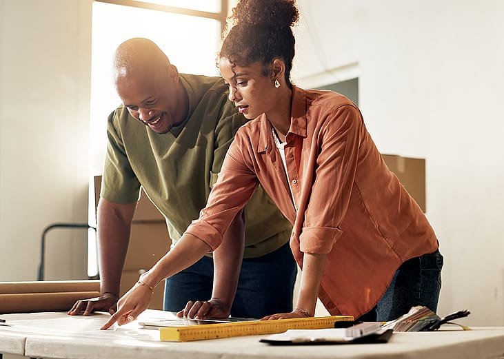 A couple reviewing renovation plans for their home.