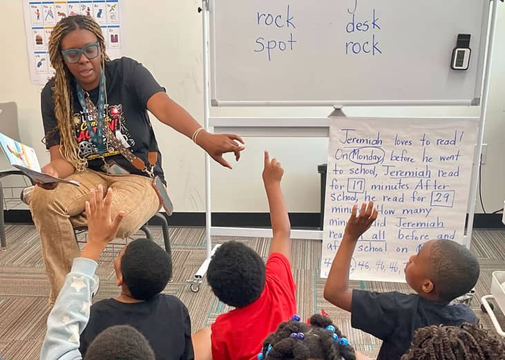 Legacy Prep teacher Maria Coleman led rising second graders in reading a story in Birmingham, Alabama where the charter school is one of more than 450 participating in Bloomberg Philanthropies Summer Boost program.