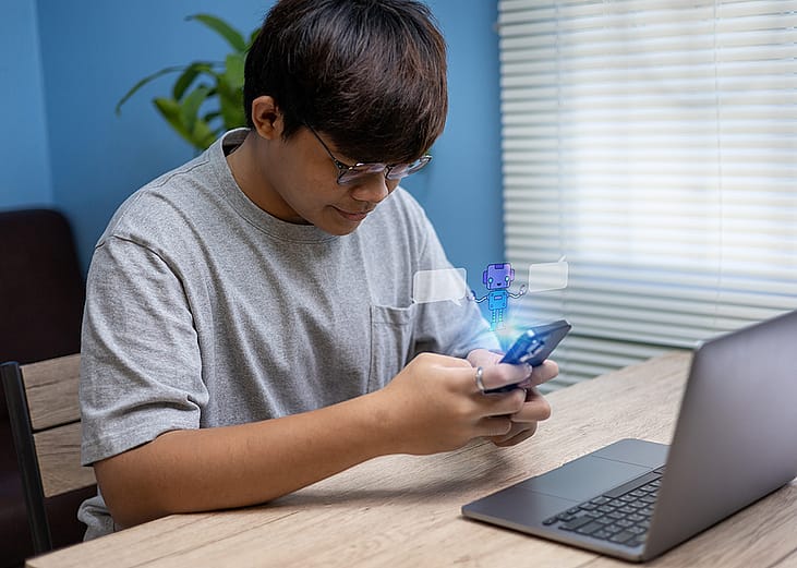 A teenage boy using smartphone at home illustrated with an AI chatbot graphic.