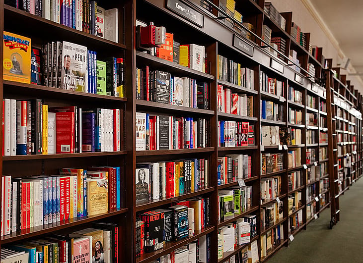 Books displayed for sale on shelves at Barnes & Noble bookstore in New York City, USA.