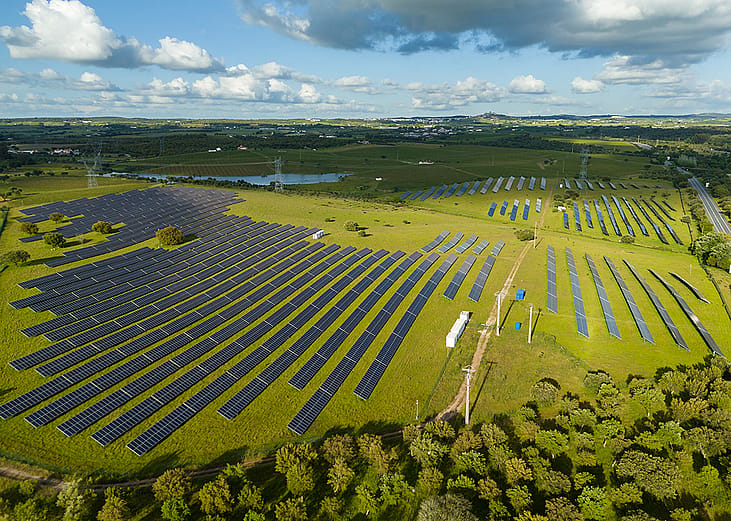 Aerial view of a field with photovoltaic solar panels.