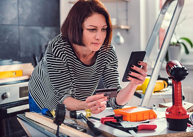 A person shopping for additional construction materials online after a kitchen renovation.