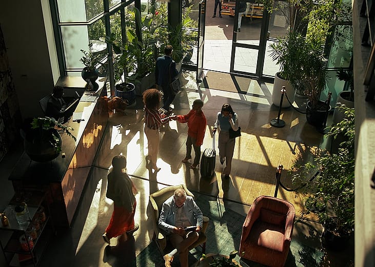 Guests arriving to check in at a hotel lobby.