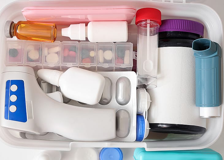 First aid kit with medical supplies arranged in a container box.