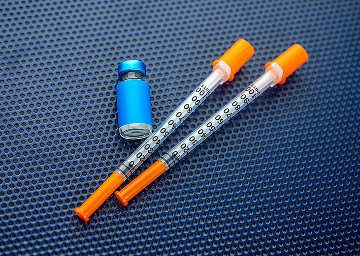 Single-use syringes and a medicine vial
