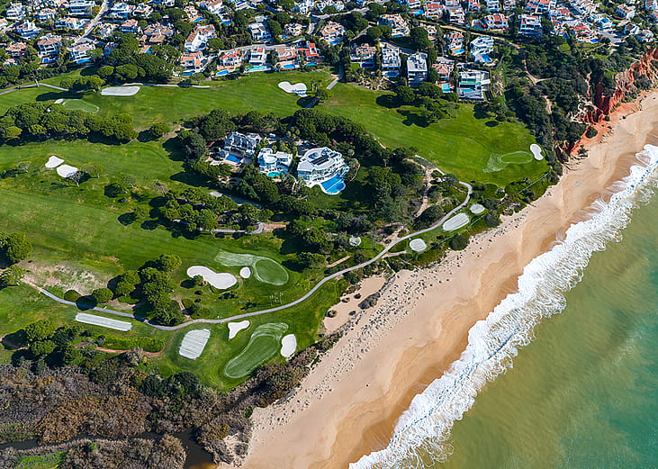 Aerial view of the iconic Crimson Cliffs of Praia do Trafal in Algarve, Portugal.
