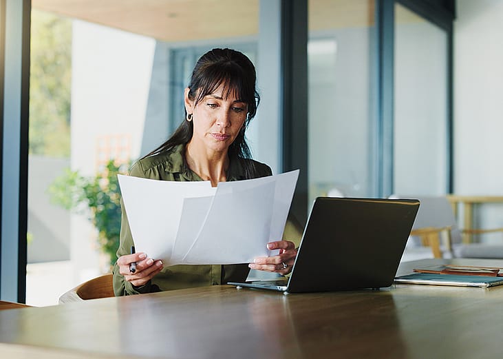 A woman reviewing property and business documents.