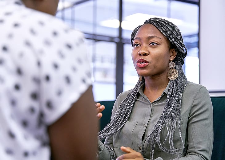 A businesswoman explaining information to a colleague.