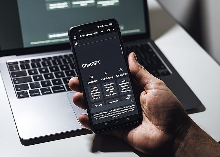 A person looking through a ChatGPT application from his smartphone.