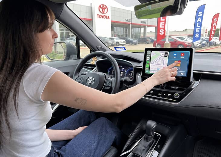 A women checking her car's destination settings.
