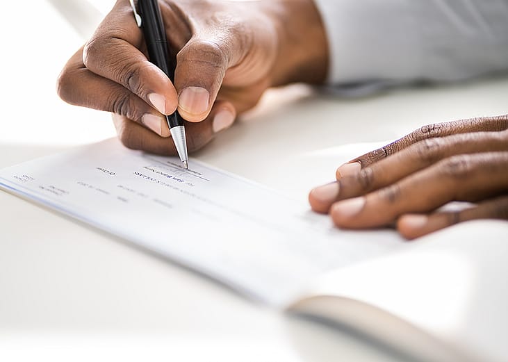 Person writing a check