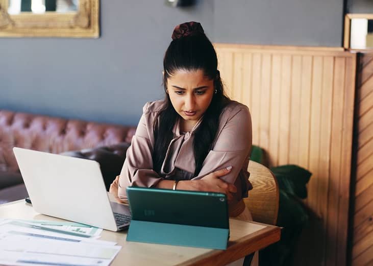 A businesswoman carefully reviewing work reports.