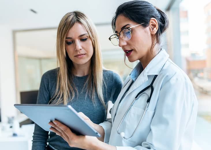 A female doctor helping her patient with consultation results.
