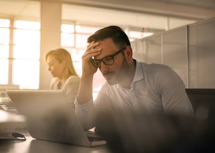 A stressed businessman at work.