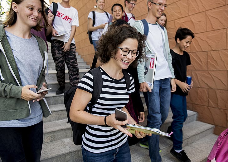 Students walking down the stairs after a class. 
