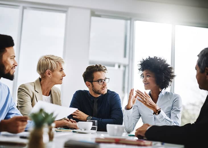 Business managers discussing the future of talent in their workplace from a meeting room.