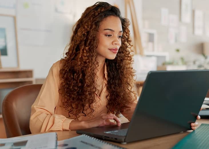 A businesswomen reviewing reports in the office.