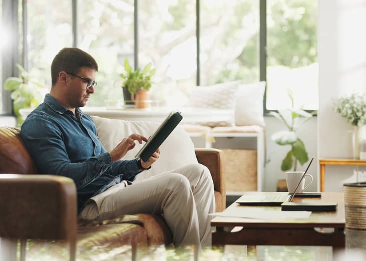 An account manager working on a client portfolio and research before an online meeting at home.