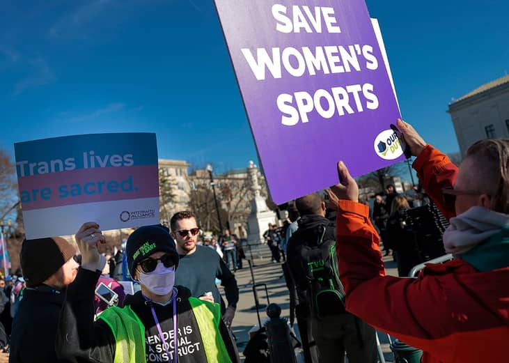 Protesters for and against transgender athletes competing in women's sports gather outside the Supreme Court on January 13, 2026 in Washington, DC. 