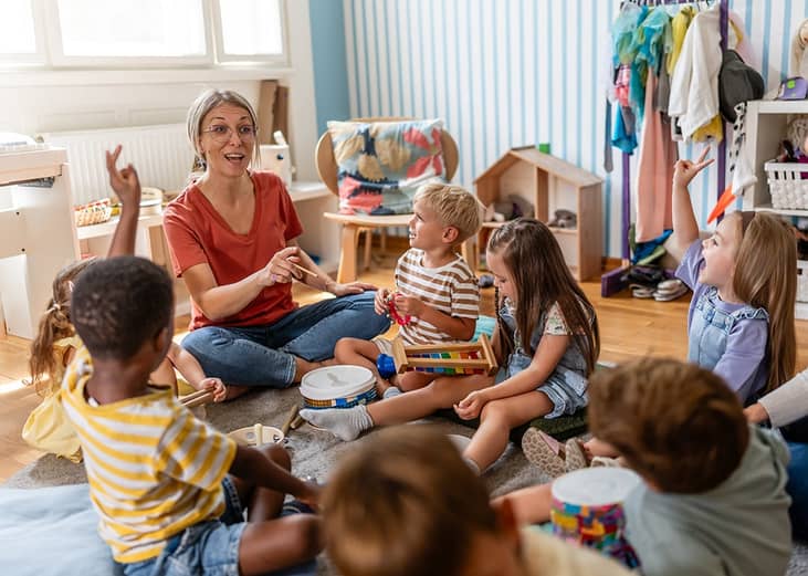 A preschool teacher leading her class with a fun interactive activity.