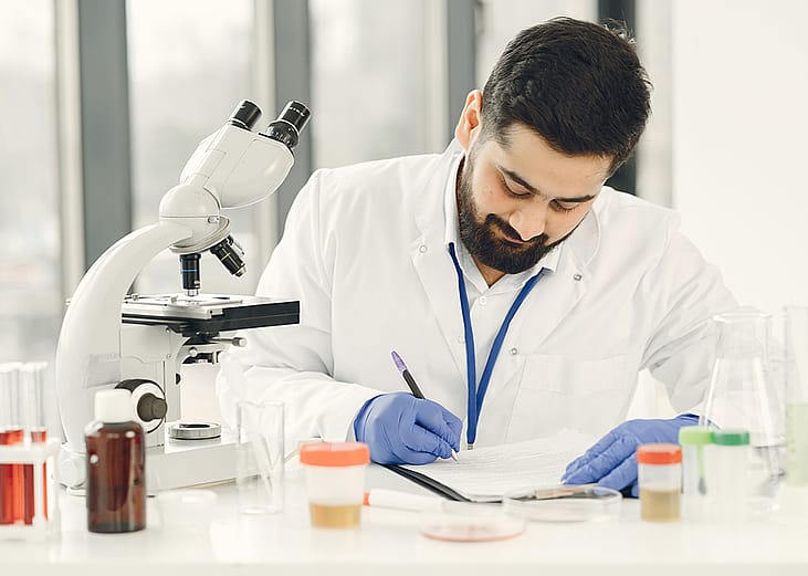 A medical technologist completing diagnostic results of patients in a clinical laboratory.