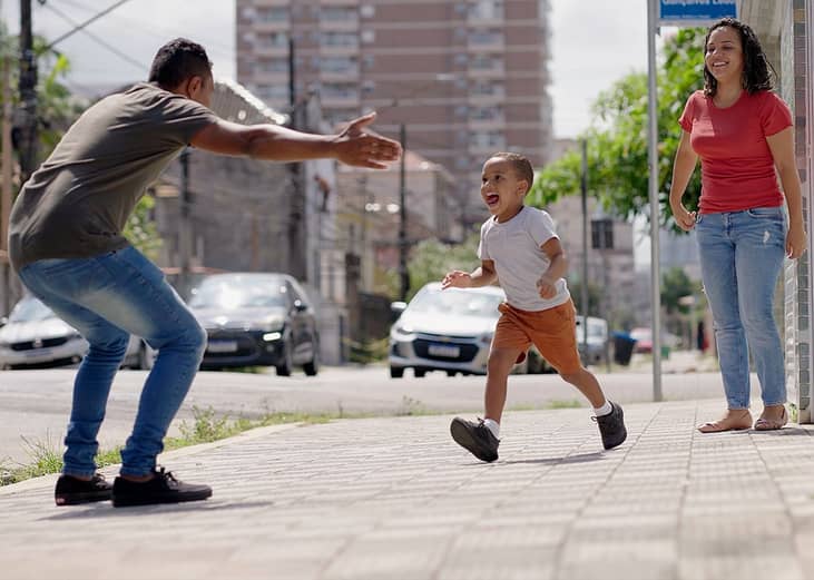 A child running to his father from his mother before day's out.