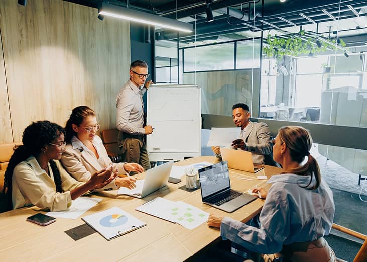 A business team brainstorming and discussing a report.