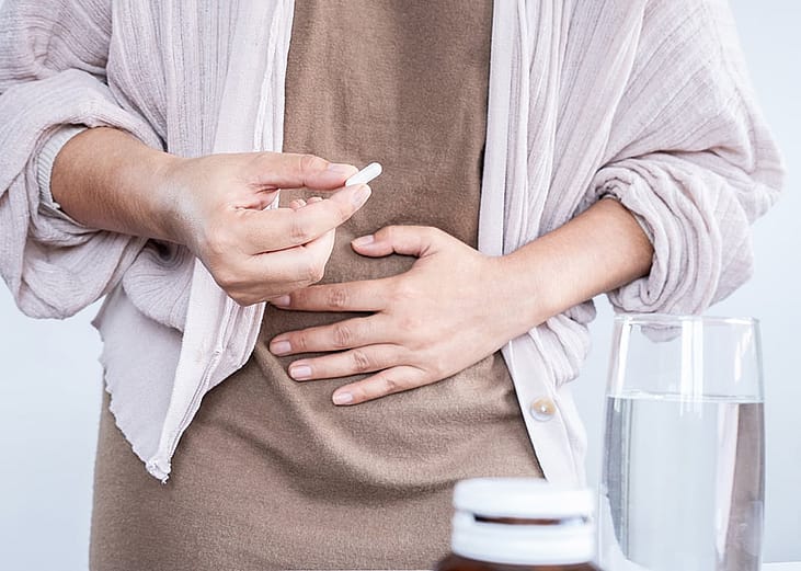 Person taking a probiotic pill
