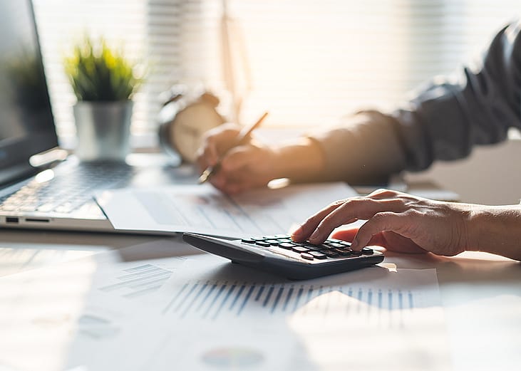 An entrepreneur calculating a business' balances before tax deduction planning. 