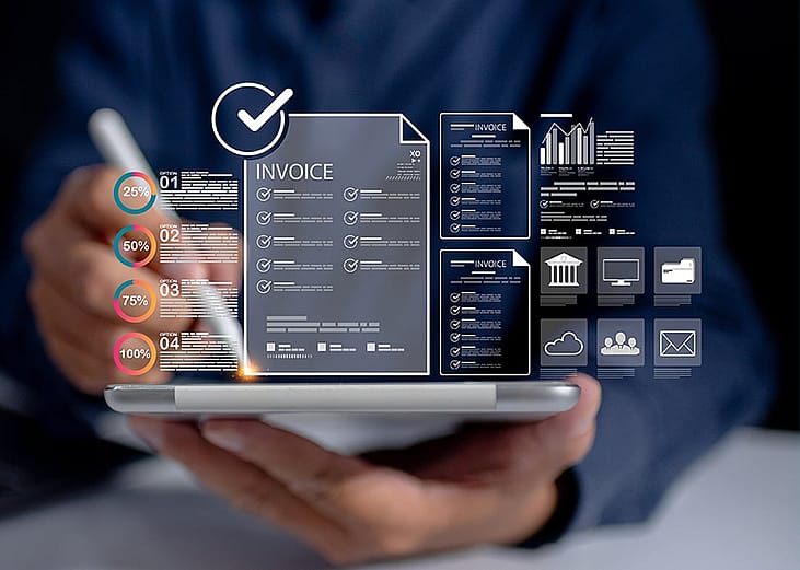 A finance analyst utilizing an automated and central invoice database and related management data charts from a work tablet.