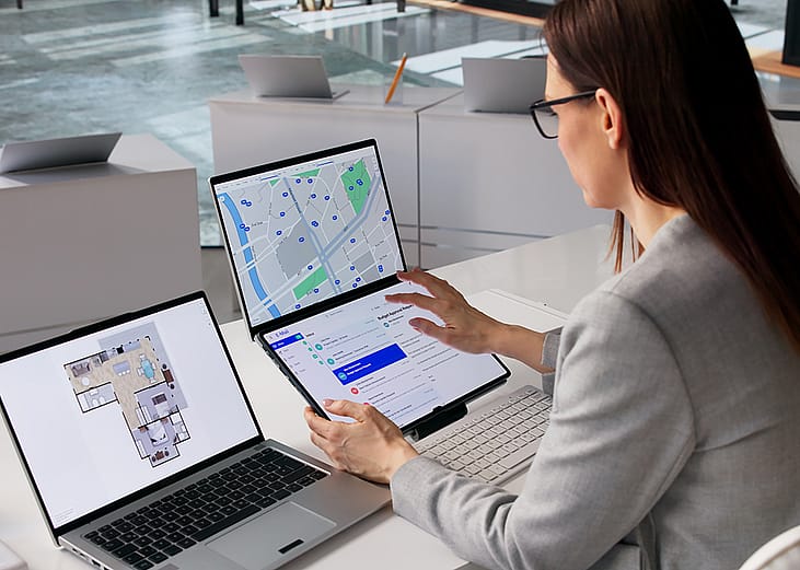 A female real estate agent organizing property listings.