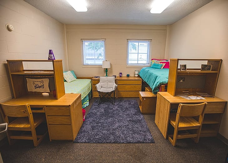 A college dorm room with two single beds.