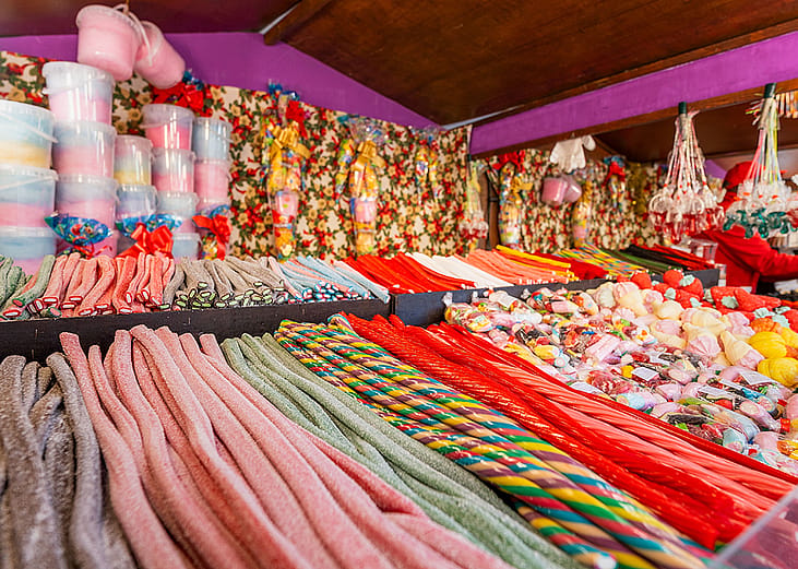 A vibrant candy stall with colorful licorice, marshmallows, and assorted sweets display.
