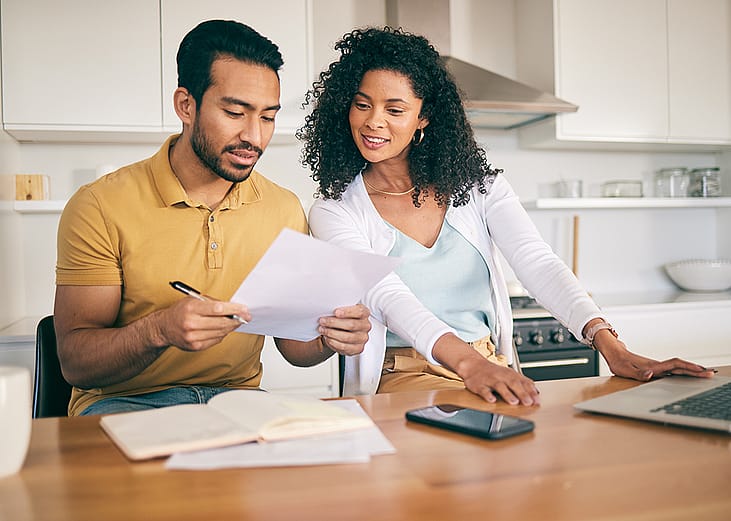 A couple reviewing bills together at home.