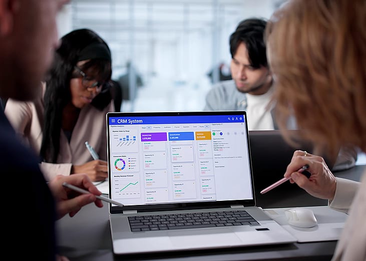 A business team using CRM software in an office.