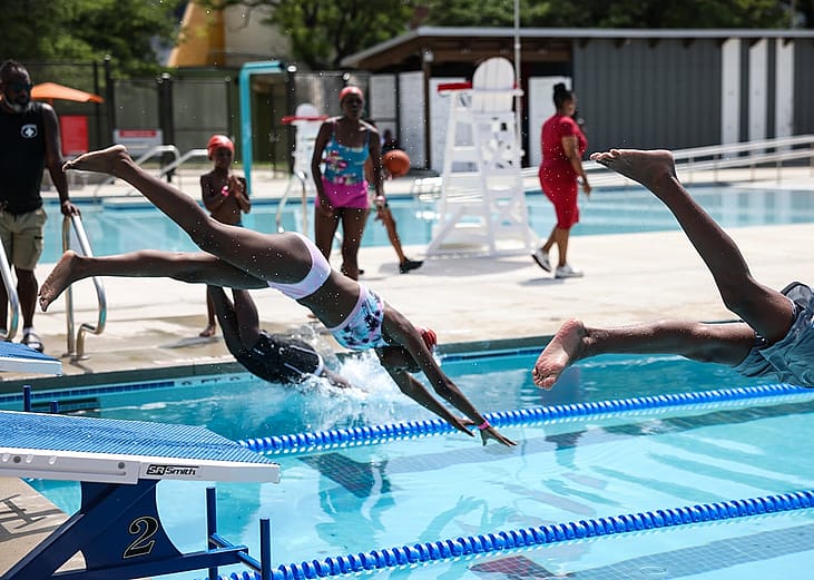 Children diving into a pool