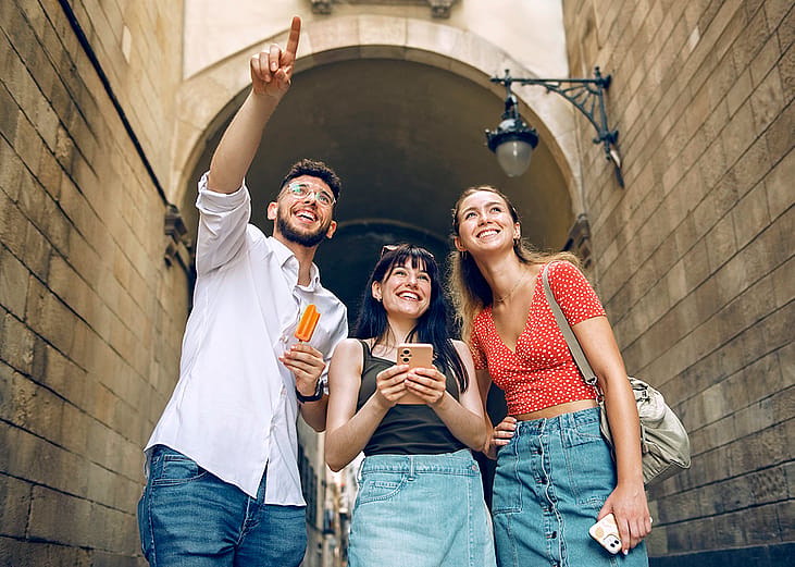 A group of three friends out and about sightseeing in a city.
