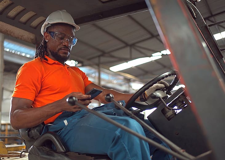 A factory worker operating a forklift