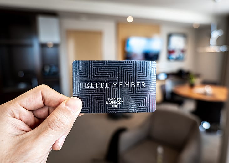 Person holding an elite membership card for a hotel