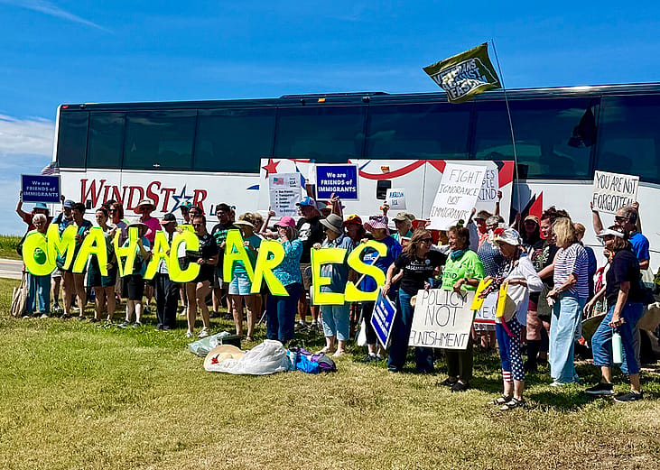 Protestors traveled 10 hours round trip on a bus road to attend an Aug. 15 rally within eyeshot of a McCook, Nebraska-based U.S. Immigration and Customs Enforcement detention center that started holding migrants last November. The rally marks a year since Gov. Jim Pillen’s administration announced a partnership with ICE to house immigrant detainees.